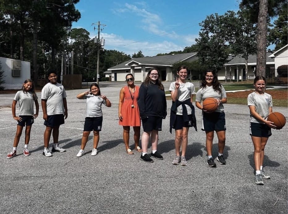 Several students playing basketball